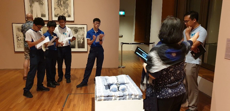 Students from Nan Chiau High School on a docent-guided tour of Awakenings.