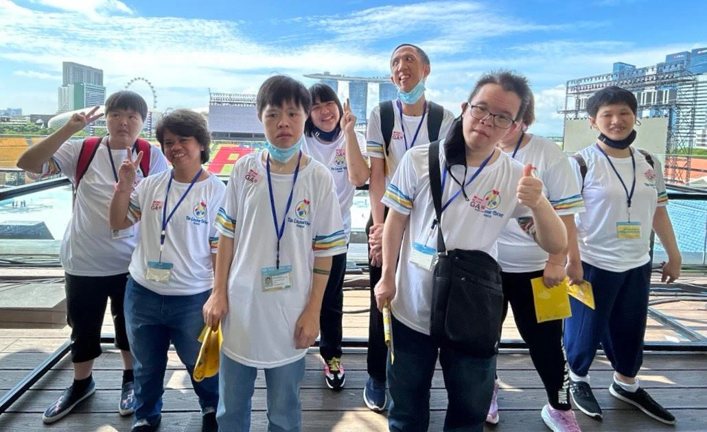 Participants from MINDS posing for a photo at Padang Deck