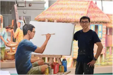 Singaporean Artist Yip Yew Chong pictured with his 3D mural of A Stroll in the Painting