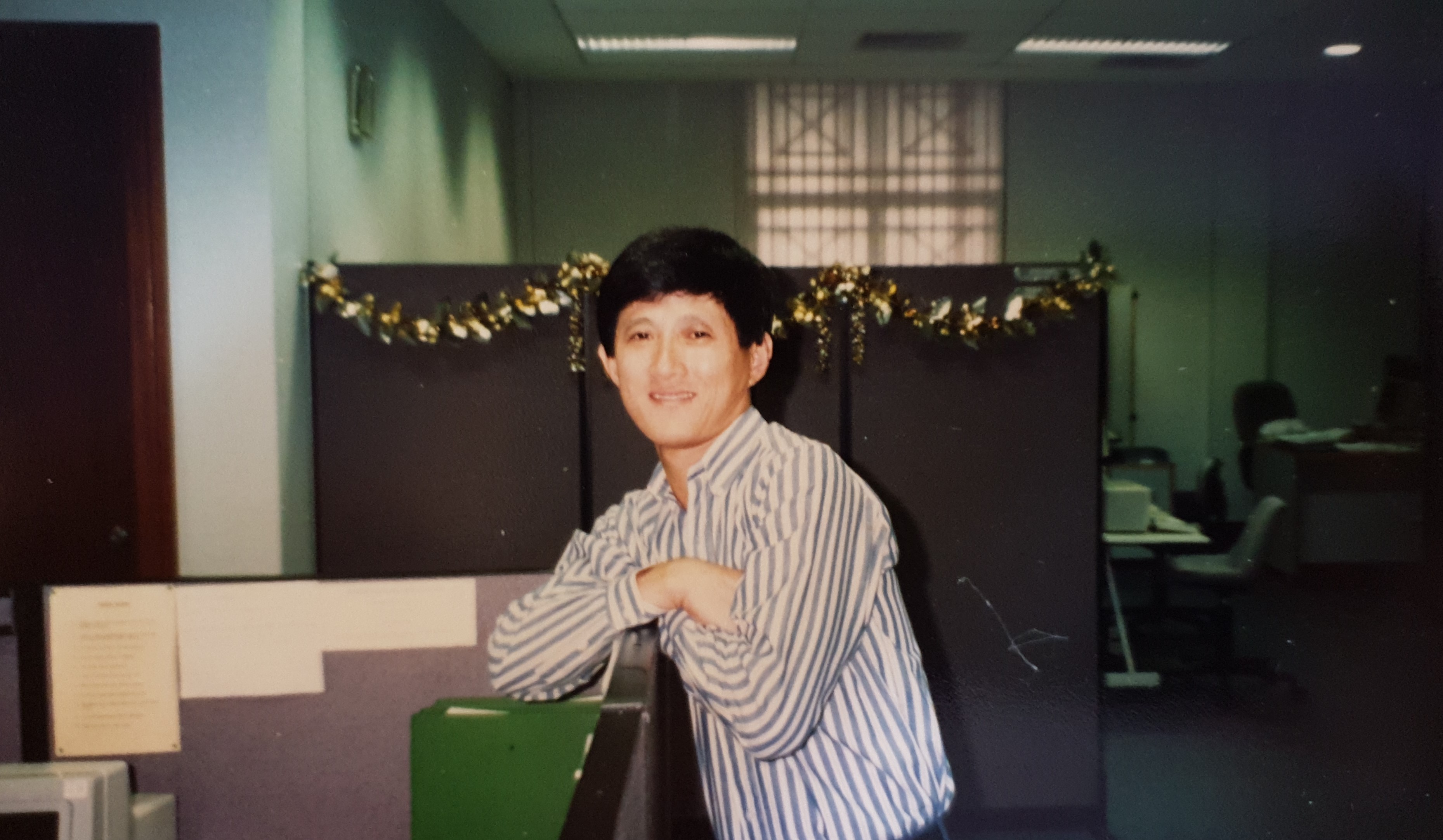 William at his cubicle at Public Service Commission, early 2000s